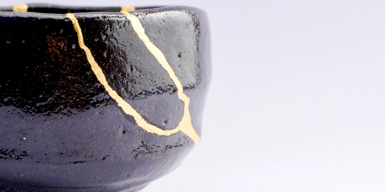 A cracked vase with gold repairs